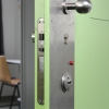Detention room door with inmate lock